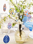 Blossom branches and egg hangers on Easter table