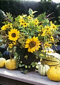 Autumnal arrangement of sunflowers, grasses, foliage etc.