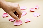 Laying out candied rose petals