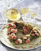 Heart-shaped wreath of Bellis and hay
