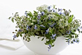 Borage and garlic chive flowers in a bowl