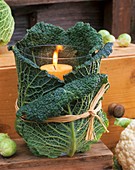 Windlight wrapped in savoy cabbage leaves tied with raffia