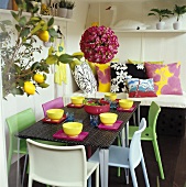 Colourful laid table with bowl of salad & floral decoration