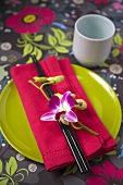 An Asian place-setting with an orchid