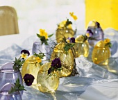 Table decoration of yellow and purple pansies