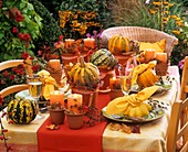 Autumnal table decoration of squashes and autumn leaves