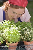 Young woman with fresh herbs