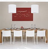A dining table with two lights above it