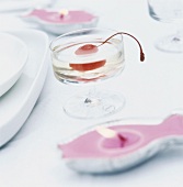 A cocktail cherry in a champagne saucer