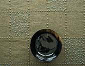 Tablecloth decorated with beads & wooden bowl