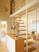 Kitchen with staircase leading to mezzanine