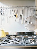 Gas hob and kitchen utensils hung on wall