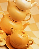 A stack of yellow teapots