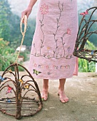 Woman wearing floral dress with cages decorated with butterflies