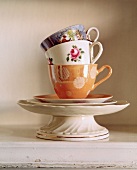 Stacked teacups, saucers and cake stand