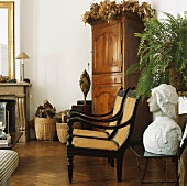 Antike Holzmöbel aus der Gründerzeit dominieren den Wohnraum mit Kamin und Fischgrätparkett