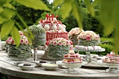 Festively decorated cakes and flower arrangments on a table