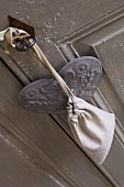 Small bag and heart hanging on key in door