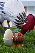Easter decorations (wooden egg in novelty egg cup, model hen)