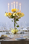 Candelabrum with yellow roses and ivy