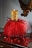 Gold candle with red decorations
