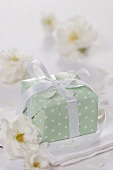 Parcel with white bow and white roses