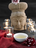 Green tea with tealights and stone figure
