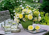 Vase of yellow roses, marguerites and campanulas