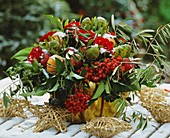 A winter bouquet of roses, ivy, rowan and ornamental apples