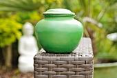 A green jar with lid in an oriental garden, Burma