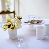 Tableware, napkins and spring flowers on table