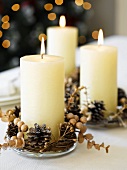 Burning candles with Christmas decorations