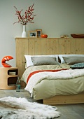 Double bed with wooden wall at head
