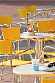Chairs and tables in front of an ice cream cafe