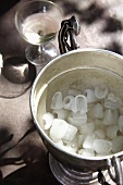Ice cubes in an ice bucket, wine glass