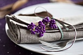 A place setting with a napkin and beautyberries