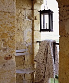 A chair, summer blanket and a lantern on a terrace