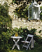 A folding table and chair in a garden