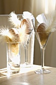 Glasses filled with feathers and Easter decoration