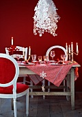 A table laid fro Christmas dinner with designer lamps