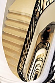 Looking down on a stairway with black banisters in a manor house