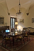 Vaulted ceiling in a dining room with antique table and chairs