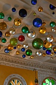 Colorful metal balls hanging from a ceiling