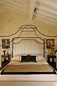 Bedroom beneath a ceiling -- elegant canopy bed frame made of curved metal