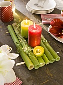 A Christmas atmosphere on an old wooden table with coloured candles
