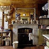 A country house kitchen with rustic charm - preserving jars in front of a mirror on a mantelpiece