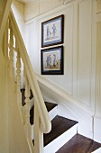 A white, wood panelled, country house-style stairway