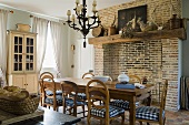 A dining room in a country house and a brick wall with a fireplace