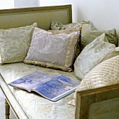 A antique seat covered with cushions