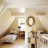 A bedroom with two single beds in a 19th century German thatched-roof house decorated in a Scandinavian style
